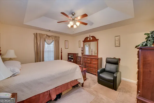 a bedroom with a bed couch and window