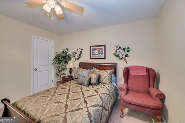 a bedroom with a bed and chair