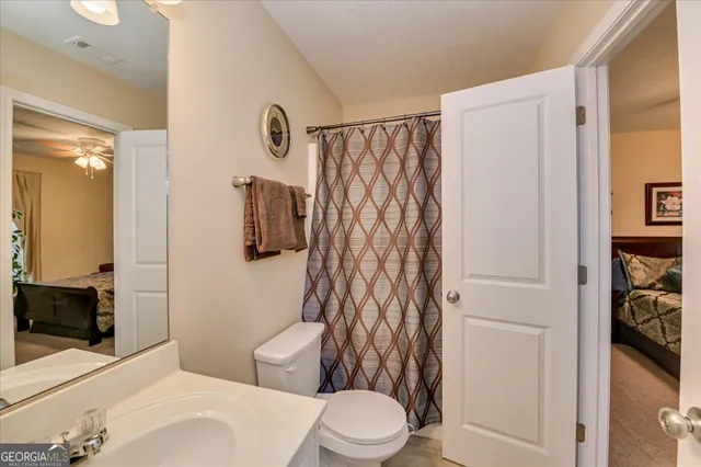 a bathroom with a toilet a sink and shower