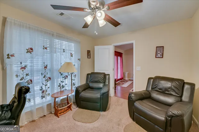 a living room with furniture flowerpot and window