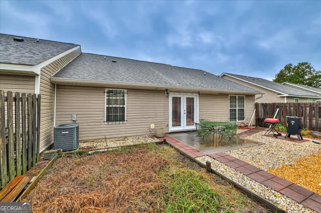 a view of a house with backyard sitting area and porch