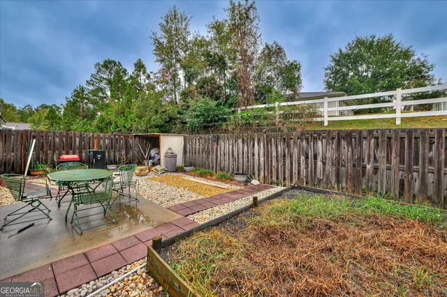 a view of a chair and fire pit in the backyard