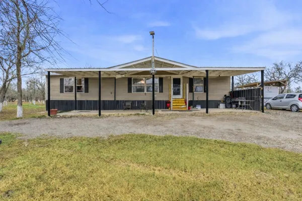 a view of a house with a backyard and porch