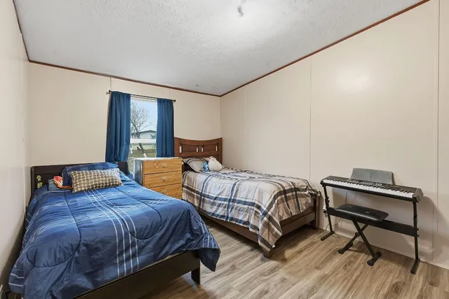 a bedroom with two beds and a desk