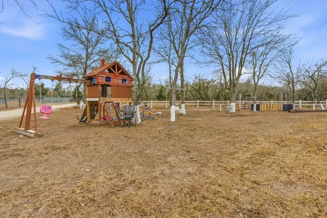 a view of outdoor space with playground and green space