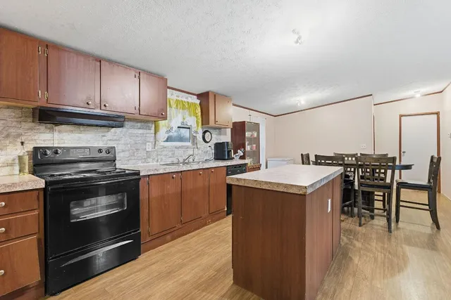 a kitchen with a stove a sink and a microwave