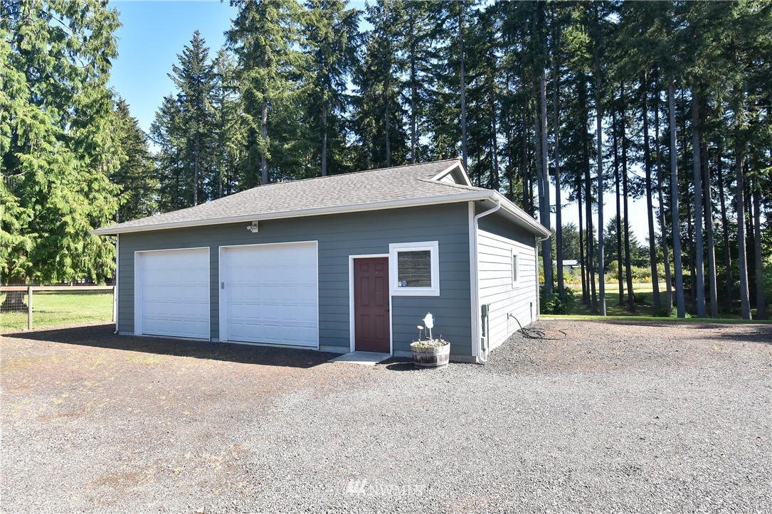 5124 133rd Avenue Southwest Rochester, WA 98579 - Photo 11 of 36 a view of a house with a yard and large tree