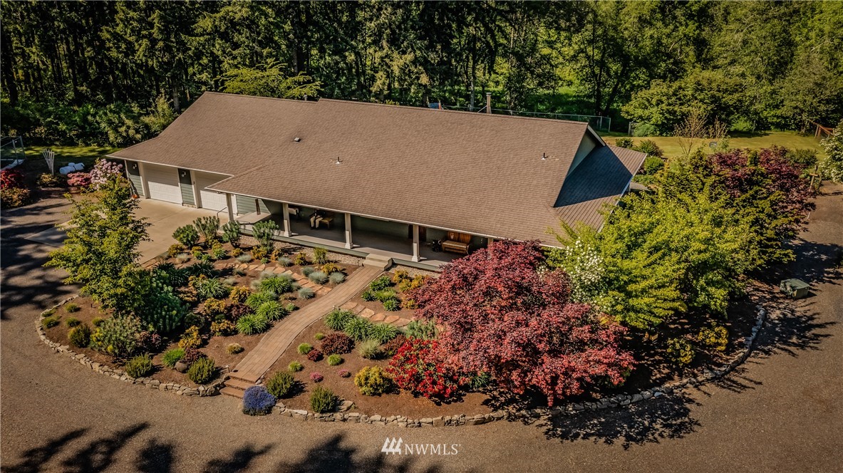 5124 133rd Avenue Southwest Rochester, WA 98579 - Photo 16 of 36 an aerial view of a house with a yard and garden