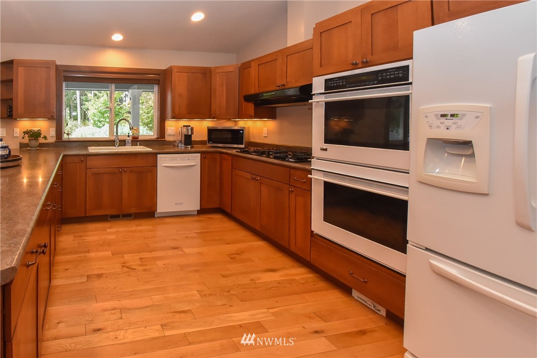5124 133rd Avenue Southwest Rochester, WA 98579 - Photo 18 of 36 a kitchen with stainless steel appliances granite countertop a stove a sink and a microwave