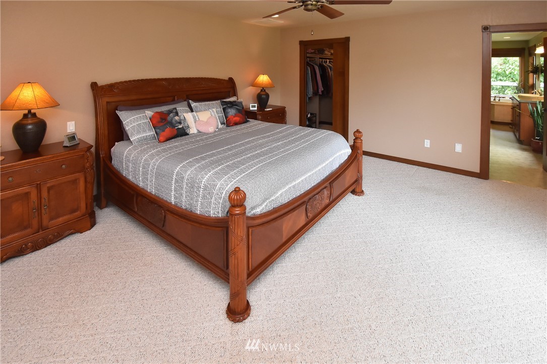 5124 133rd Avenue Southwest Rochester, WA 98579 - Photo 20 of 36 a bedroom with a bed and lamp with mirror