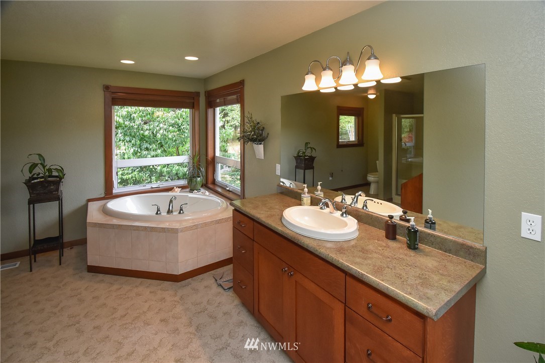 5124 133rd Avenue Southwest Rochester, WA 98579 - Photo 23 of 36 a bathroom with a tub sink and mirror