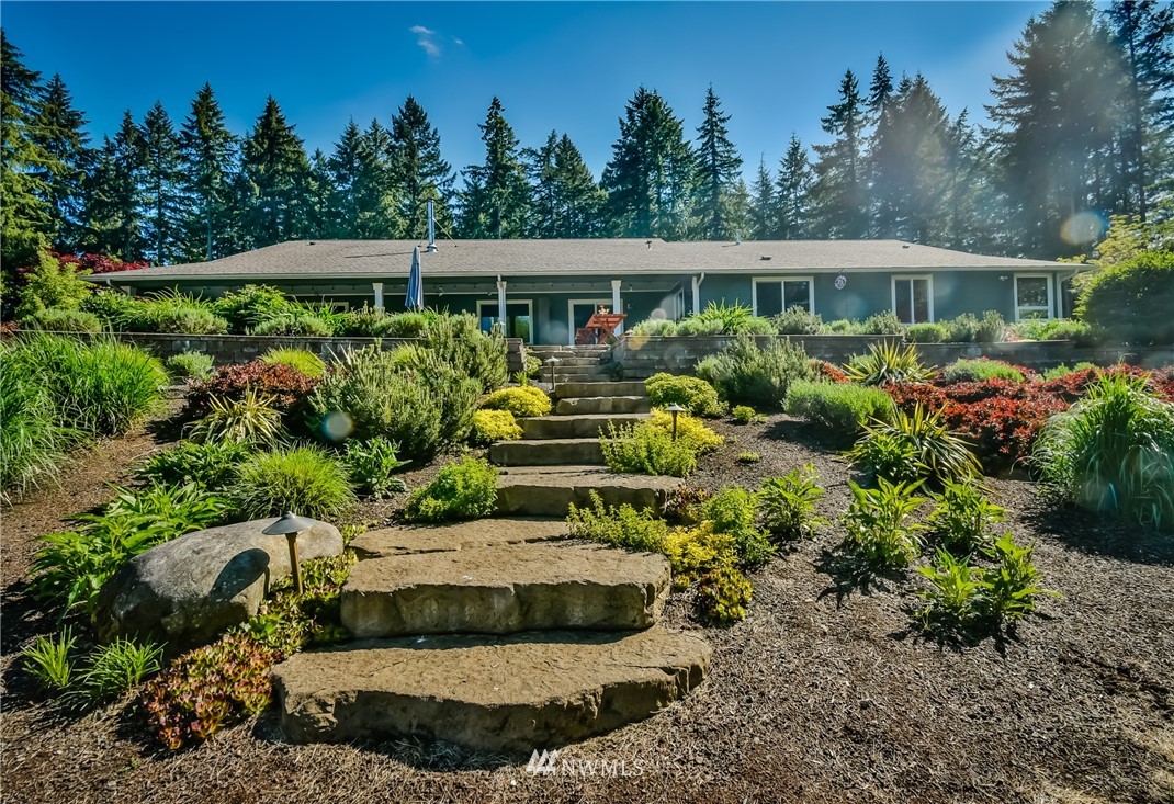 5124 133rd Avenue Southwest Rochester, WA 98579 - Photo 5 of 36 a view of a house with a yard and potted plants