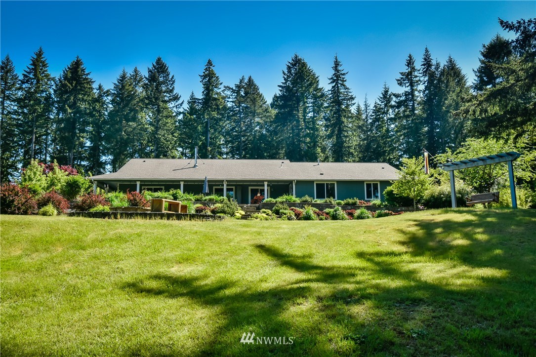 5124 133rd Avenue Southwest Rochester, WA 98579 - Photo 6 of 36 a view of a big yard next to a yard