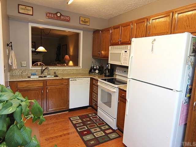 605 Broad Leaf Circle Raleigh, NC 27613 - Photo 5 of 12 a white refrigerator freezer sitting inside of a kitchen