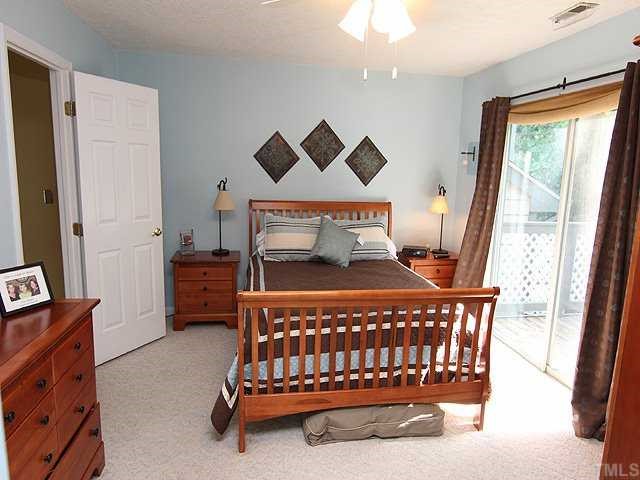 605 Broad Leaf Circle Raleigh, NC 27613 - Photo 7 of 12 a bed sitting in a bedroom next to a window