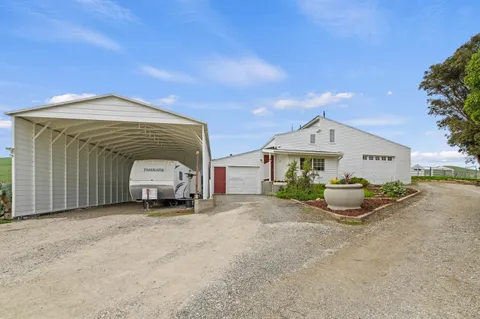 a view of a house with a yard and garage