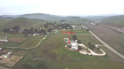 a view of a lake with a yard and outdoor seating