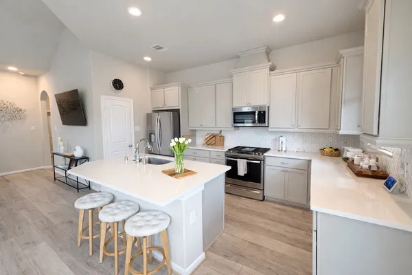 a kitchen with a table and chairs