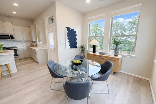 a dining room with furniture and wooden floor