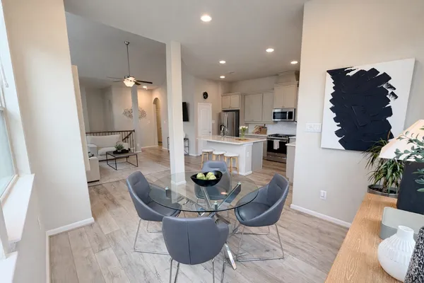 a dining room with furniture and wooden floor