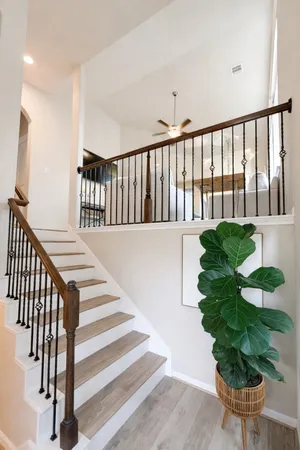 a living room with furniture a flat screen tv and kitchen view