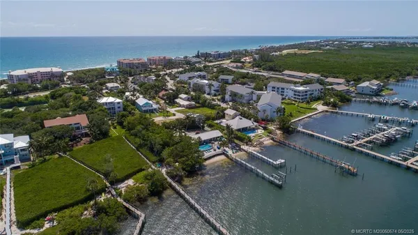 an aerial view of a houses with a yard