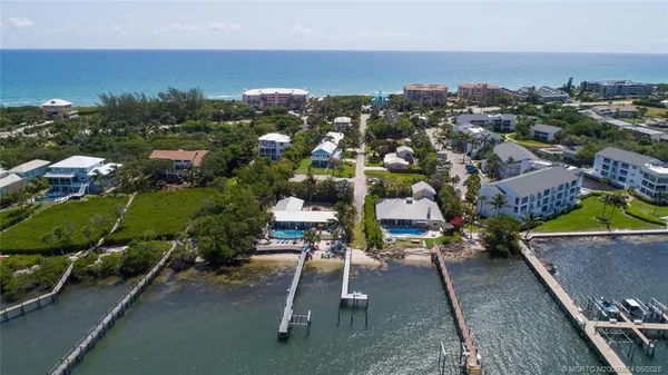 an aerial view of a houses with a yard
