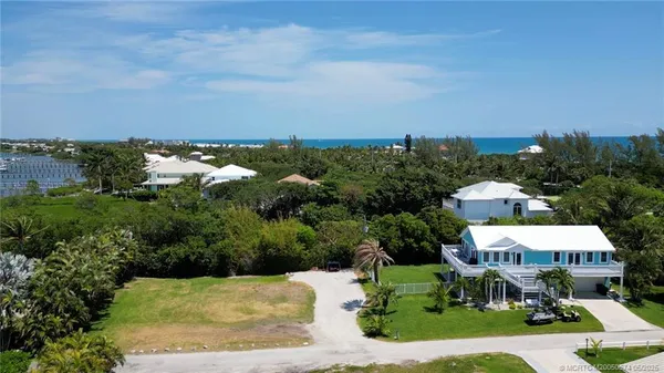 an aerial view of a house with yard swimming pool and outdoor seating