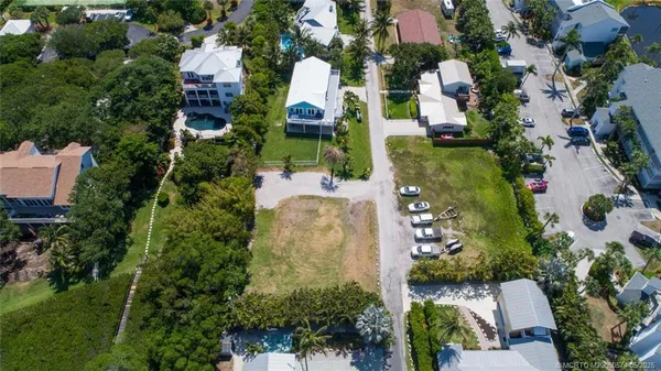 an aerial view of multiple houses with yard