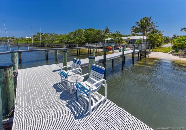 a view of a patio with dining table and chairs with a floor to ceiling window