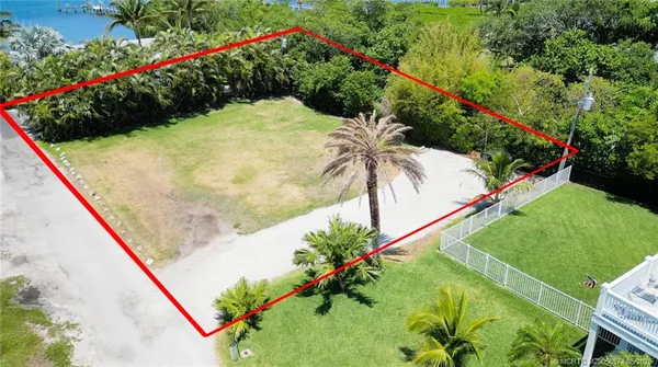 a view of swimming pool with a garden and plants