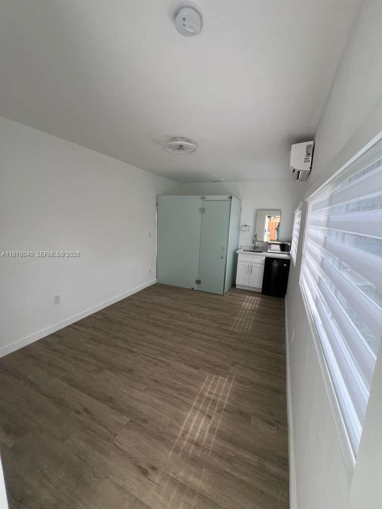 6220 Northwest 19th Street Sunrise, FL 33313 - Photo 13 of 21 a view of empty room with wooden floor and fireplace