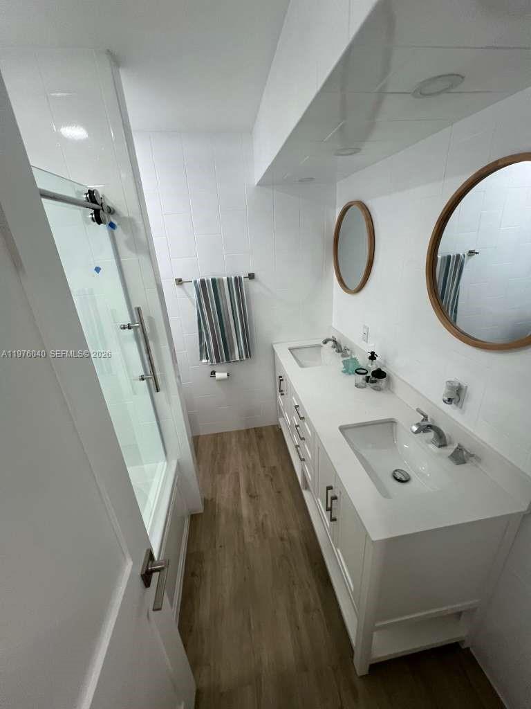 6220 Northwest 19th Street Sunrise, FL 33313 - Photo 18 of 21 a bathroom with a double vanity sink and a mirror