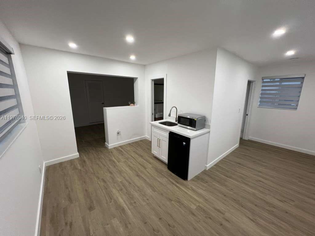 6220 Northwest 19th Street Sunrise, FL 33313 - Photo 20 of 21 a view of kitchen with microwave and cabinets