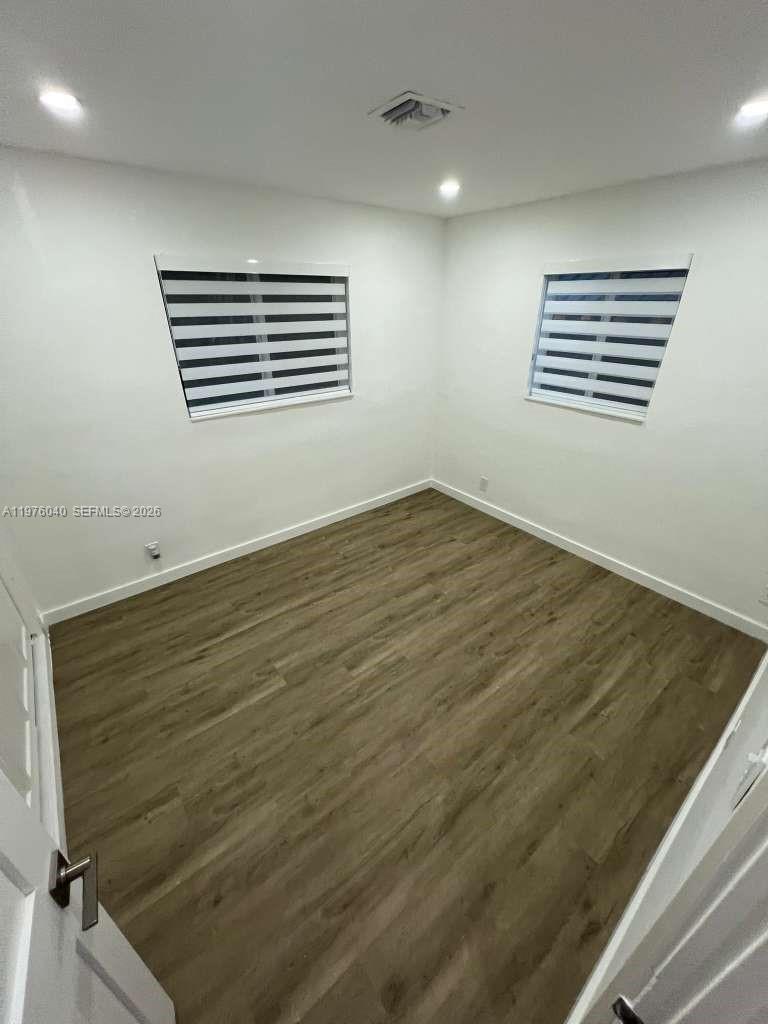 6220 Northwest 19th Street Sunrise, FL 33313 - Photo 21 of 21 an empty room with wooden floor and windows