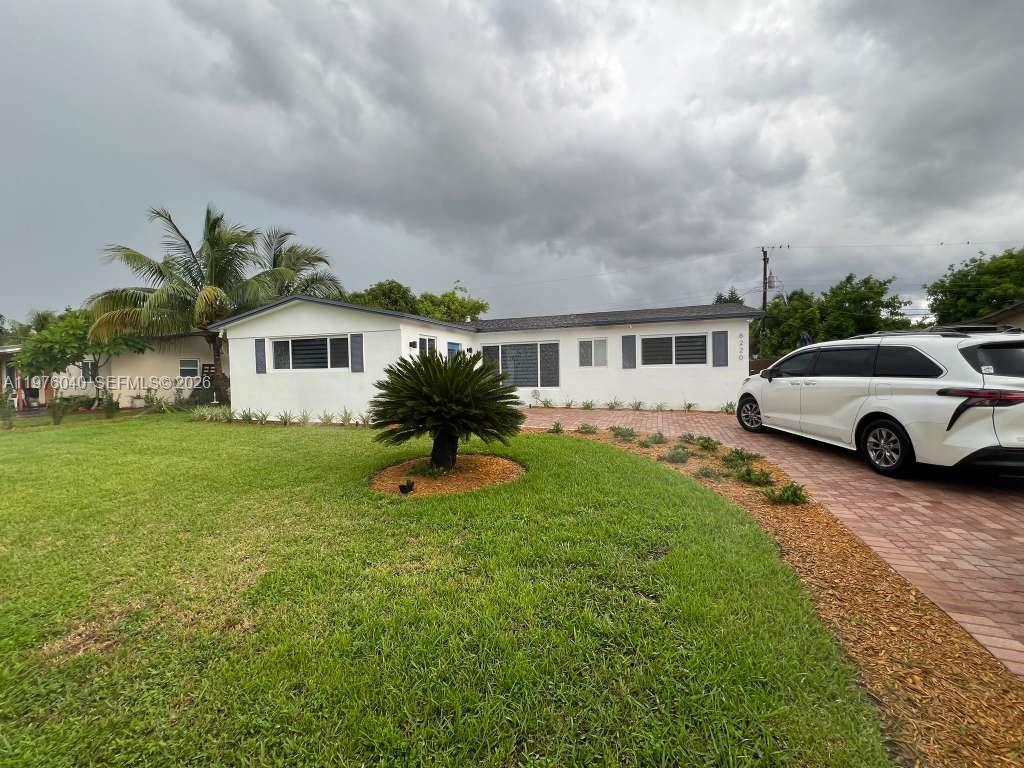 6220 Northwest 19th Street Sunrise, FL 33313 - Photo 4 of 21 a house view with a garden space