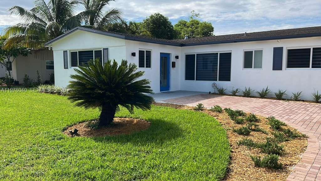 6220 Northwest 19th Street Sunrise, FL 33313 - Photo 5 of 21 a house view with a garden space