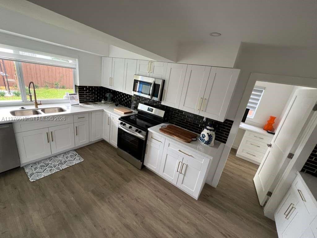 6220 Northwest 19th Street Sunrise, FL 33313 - Photo 8 of 21 a kitchen with a sink appliances and cabinets