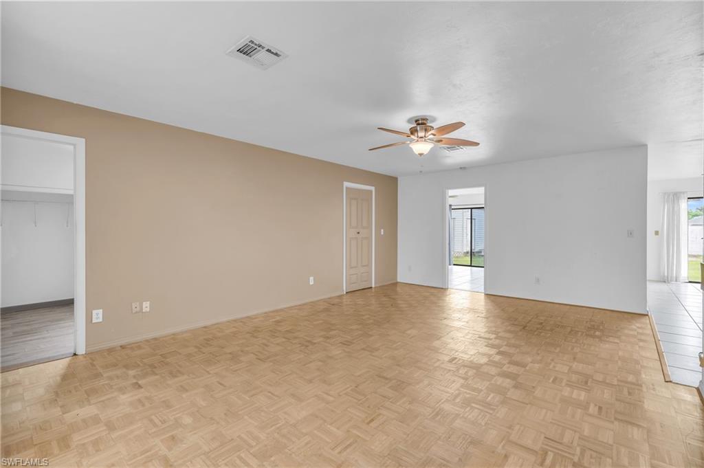 2264 53rd Street Southwest Naples, FL 34116 - Photo 11 of 40 Unfurnished room featuring light parquet flooring and ceiling fan