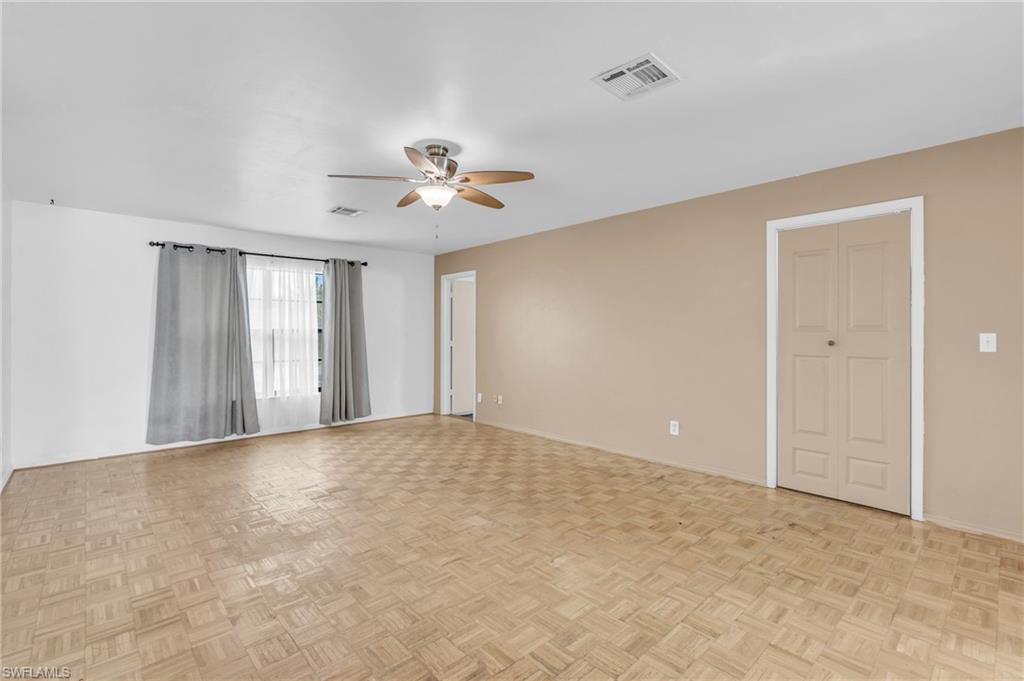 2264 53rd Street Southwest Naples, FL 34116 - Photo 12 of 40 Unfurnished room featuring ceiling fan and light parquet floors