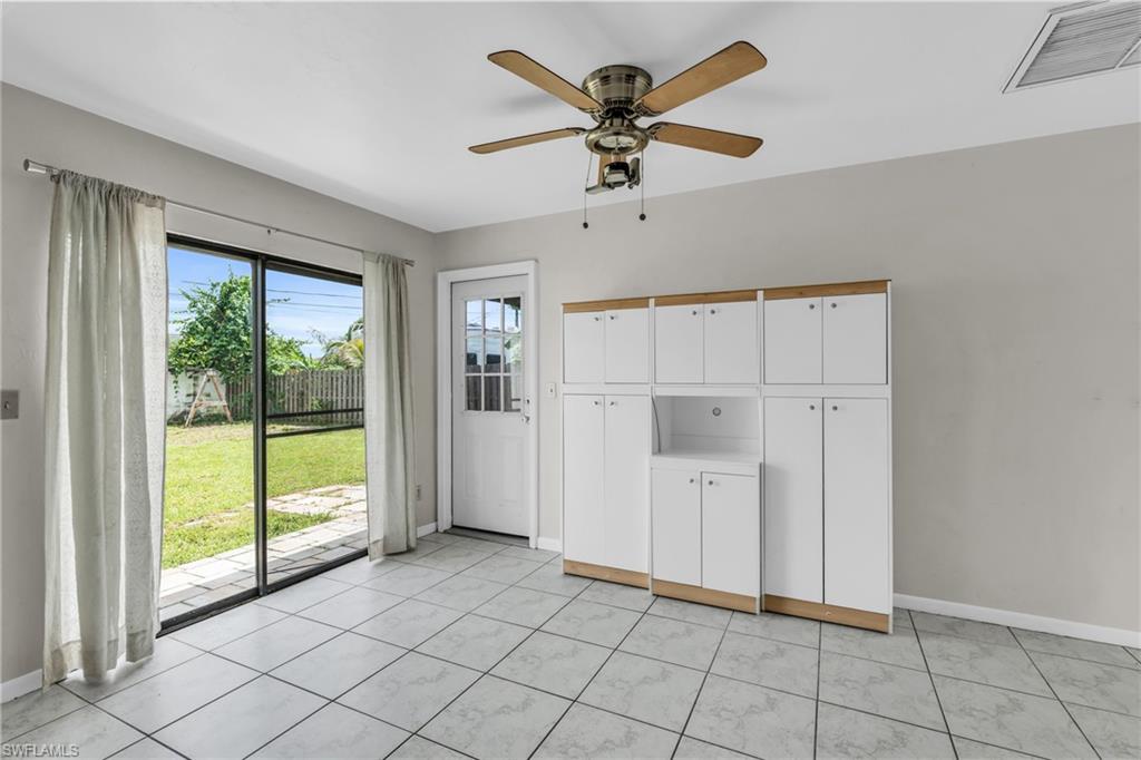 2264 53rd Street Southwest Naples, FL 34116 - Photo 17 of 40 Unfurnished living room with light tile patterned floors and ceiling fan