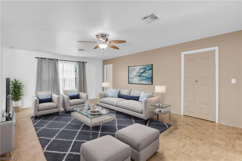 2264 53rd Street Southwest Naples, FL 34116 - Photo 2 of 40 Living room featuring parquet floors and ceiling fan