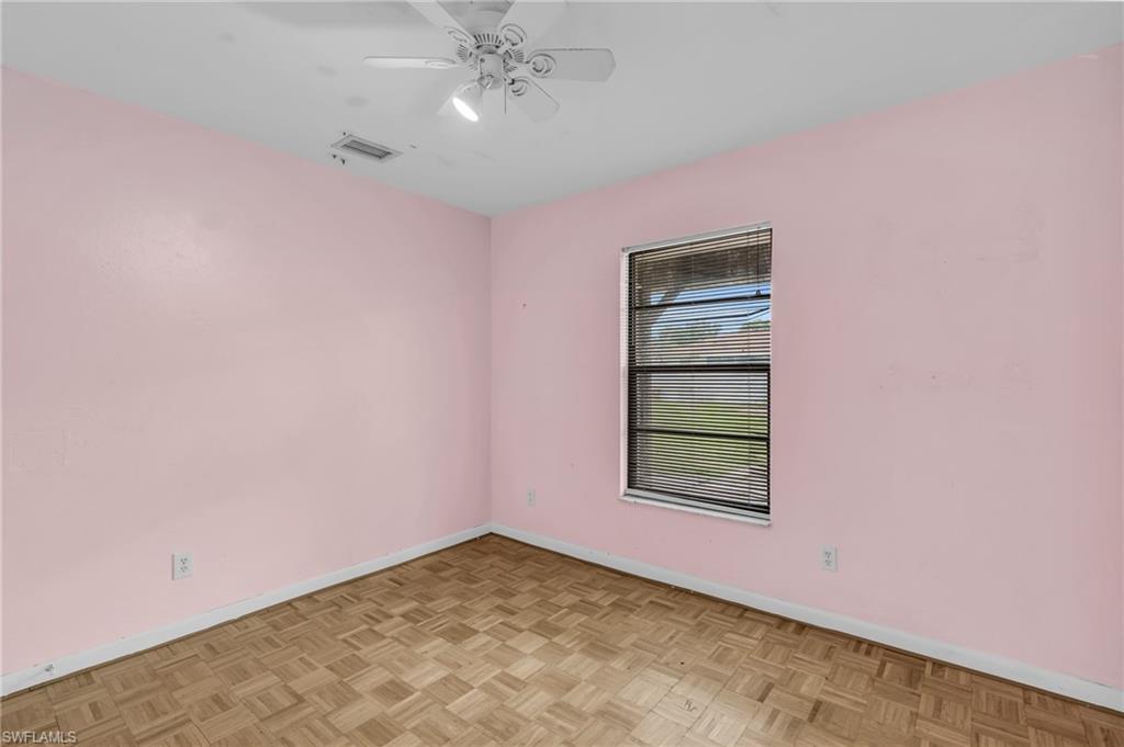 2264 53rd Street Southwest Naples, FL 34116 - Photo 23 of 40 Empty room featuring light parquet floors and ceiling fan