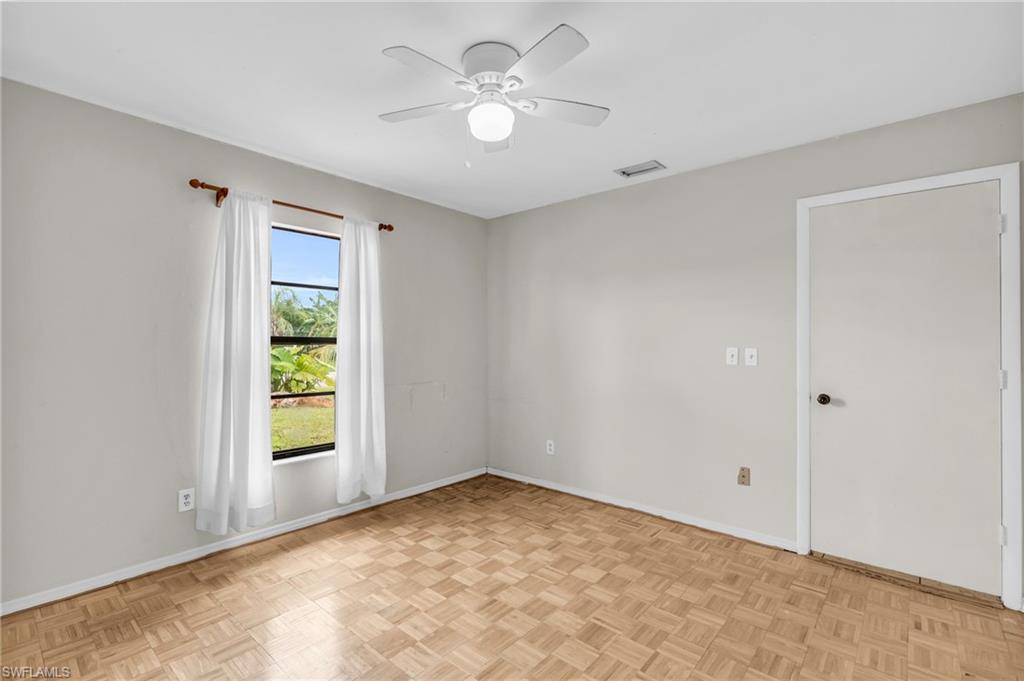 2264 53rd Street Southwest Naples, FL 34116 - Photo 26 of 40 Empty room featuring light parquet flooring and ceiling fan