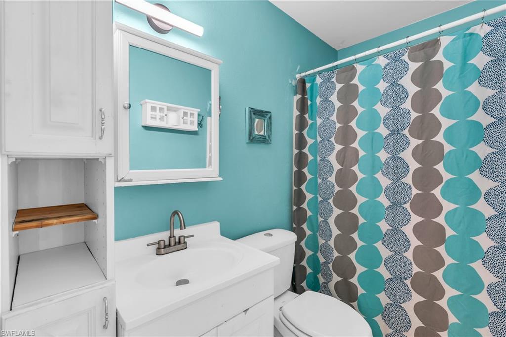 2264 53rd Street Southwest Naples, FL 34116 - Photo 27 of 40 Bathroom featuring vanity, toilet, and a shower with shower curtain