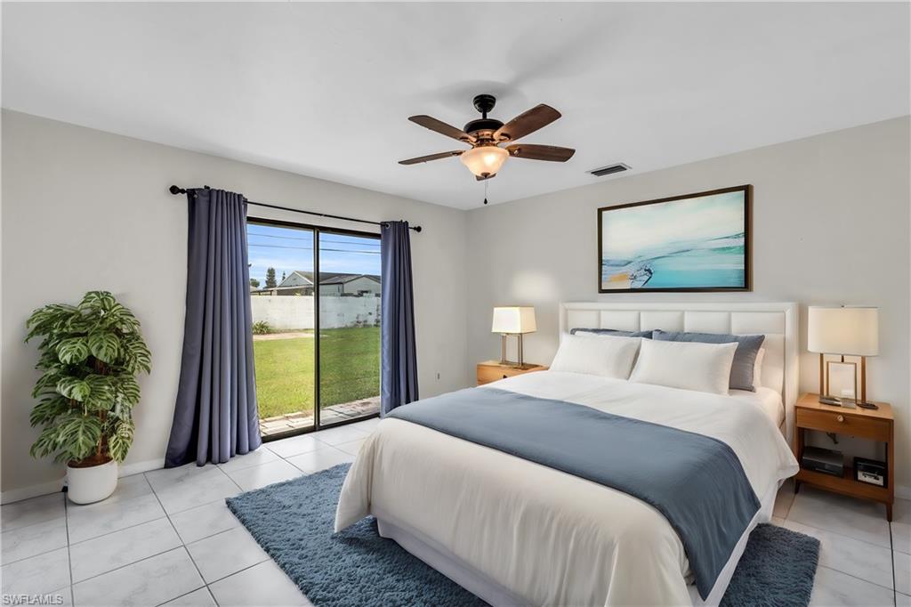 2264 53rd Street Southwest Naples, FL 34116 - Photo 5 of 40 Bedroom with ceiling fan, light tile patterned flooring, multiple windows, and access to outside