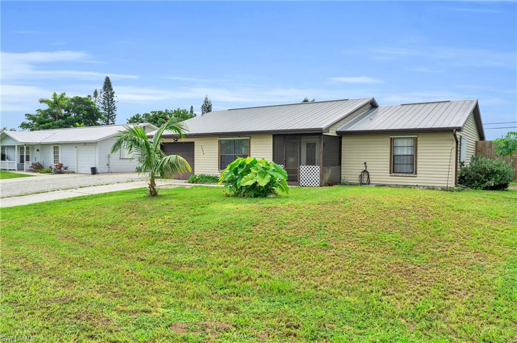 2264 53rd Street Southwest Naples, FL 34116 - Photo 6 of 40 Ranch-style house featuring a front lawn