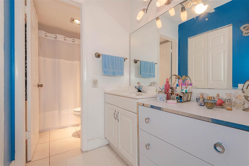 9351 Lime Bay Boulevard, Unit 207 Tamarac, FL 33321 - Photo 17 of 27 a bathroom with a sink and a mirror