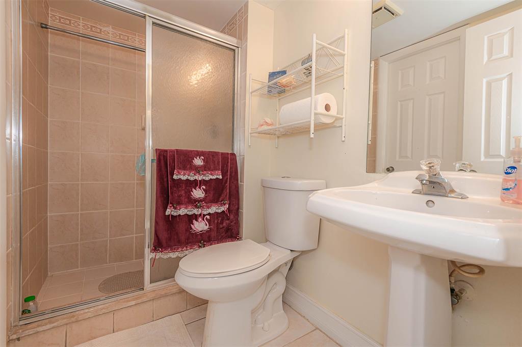 9351 Lime Bay Boulevard, Unit 207 Tamarac, FL 33321 - Photo 23 of 27 a bathroom with a sink a toilet and shower