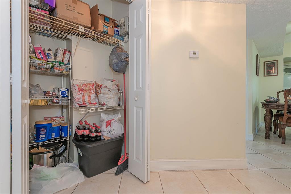 9351 Lime Bay Boulevard, Unit 207 Tamarac, FL 33321 - Photo 24 of 27 a room with lots of different colored cloths
